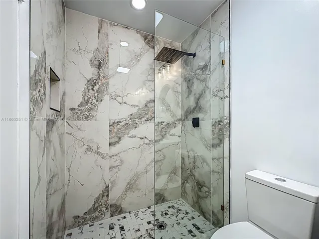 a bathroom with a shower and a toilet