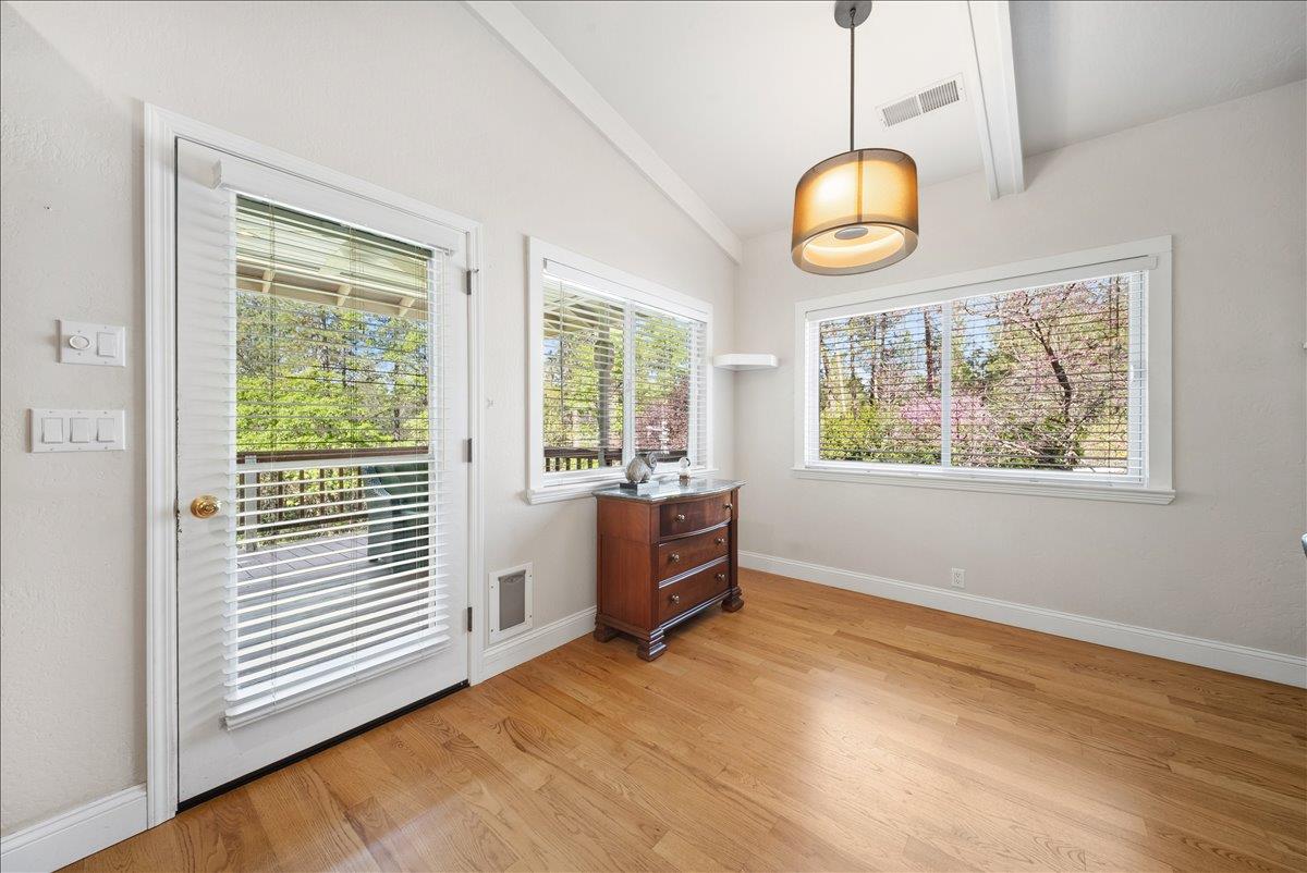 27769 Table Meadow Road Auburn, CA 95602 - Photo 11 of 43 an empty room with wooden floor and windows