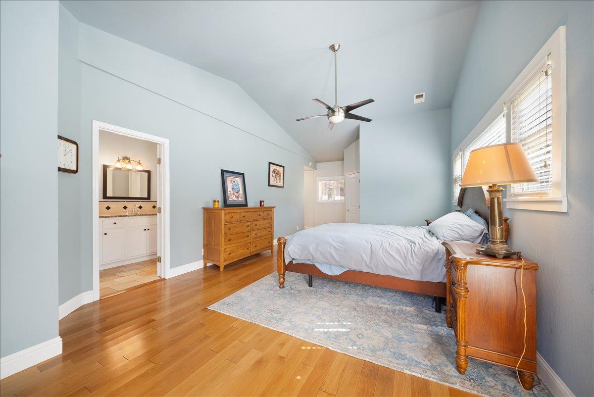 27769 Table Meadow Road Auburn, CA 95602 - Photo 13 of 43 a spacious bedroom with a bed and wooden floor