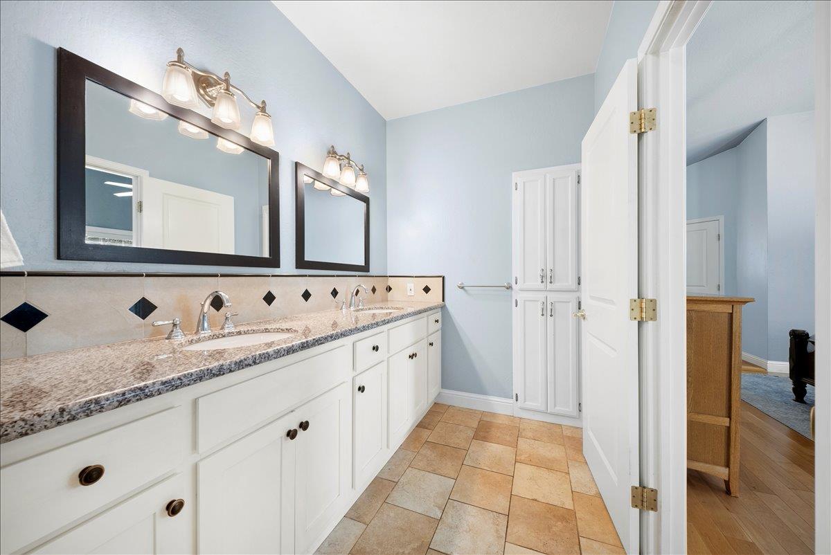 27769 Table Meadow Road Auburn, CA 95602 - Photo 14 of 43 a bathroom with a granite countertop double vanity sink and mirror