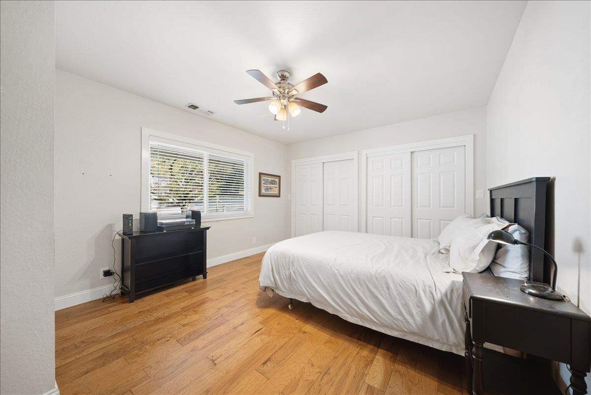 27769 Table Meadow Road Auburn, CA 95602 - Photo 18 of 43 a bedroom with a bed and wooden floor