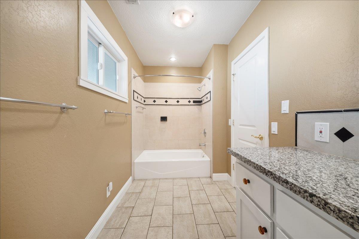 27769 Table Meadow Road Auburn, CA 95602 - Photo 22 of 43 a bathroom with a granite countertop sink a toilet and shower
