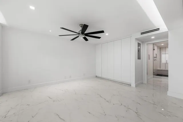 a bathroom with a double vanity sink a toilet and shower