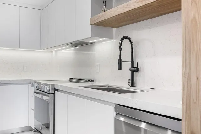 an empty room with closet and a ceiling fan