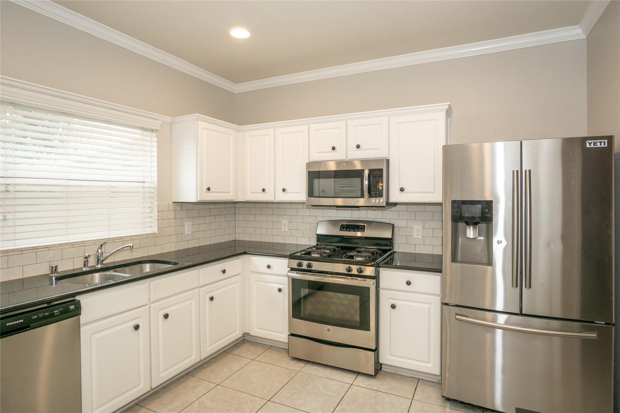 2535 Elm Crossing Trail Spring, TX 77386 - Photo 9 of 33 a kitchen with white cabinets white stainless steel appliances and sink