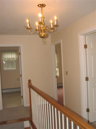 10 Rowley Hill Road Sterling, MA 01564 - Photo 15 of 29 a view of a chandelier in a hallway