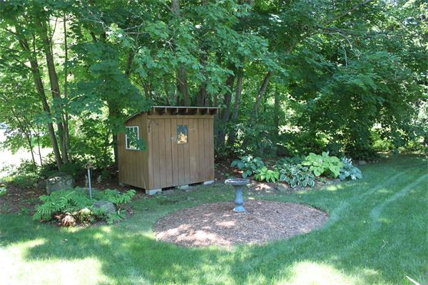 10 Rowley Hill Road Sterling, MA 01564 - Photo 23 of 29 a view of a backyard with potted plants and large trees