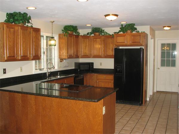 10 Rowley Hill Road Sterling, MA 01564 - Photo 4 of 29 a kitchen with stainless steel appliances granite countertop a refrigerator a sink and a stove