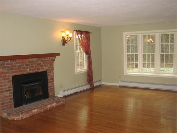 10 Rowley Hill Road Sterling, MA 01564 - Photo 9 of 29 a view of a livingroom with a fireplace and window