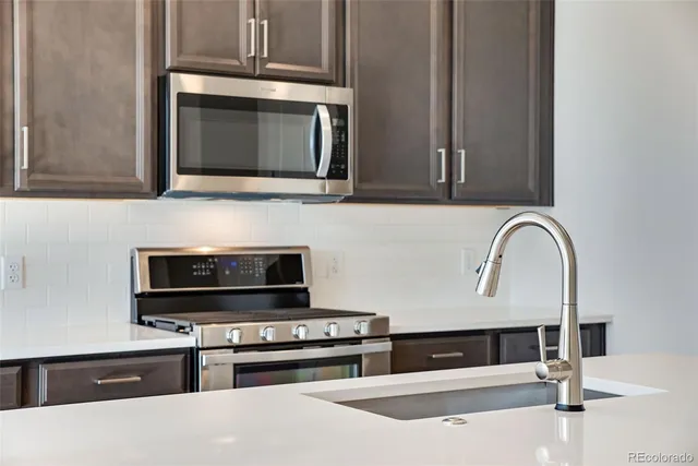 a kitchen with a stove and a microwave