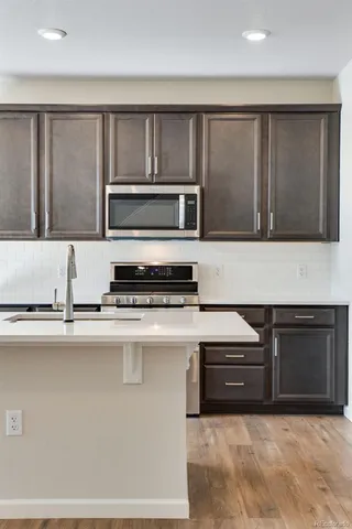 a kitchen with stainless steel appliances granite countertop a stove and a microwave