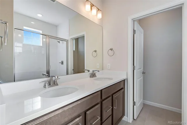 a bathroom with a sink double vanity and a mirror