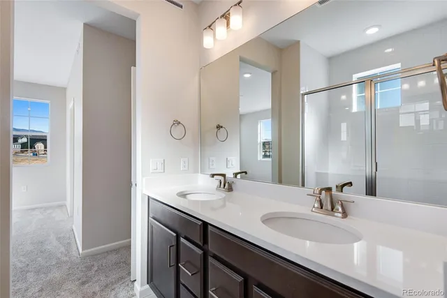 a bathroom with a double vanity sink mirror and double