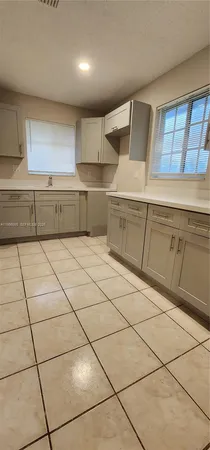a kitchen with stainless steel appliances cabinets and stove
