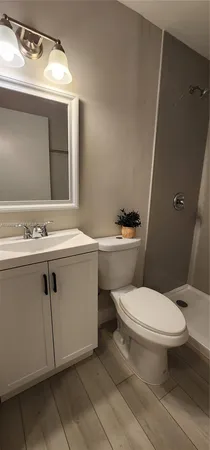 a white toilet sitting next to a bathroom sink