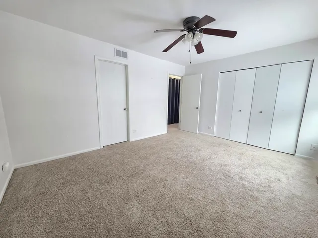 a view of empty room with ceiling fan