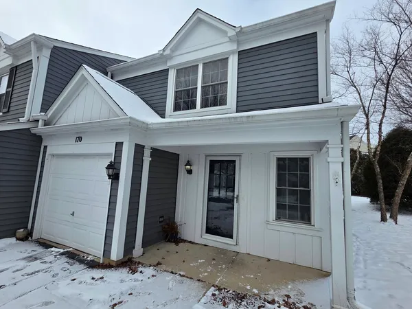 a view of a house with a door and wooden roof