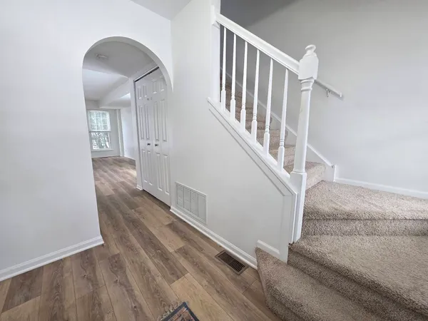 a view of entryway and hall with wooden floor