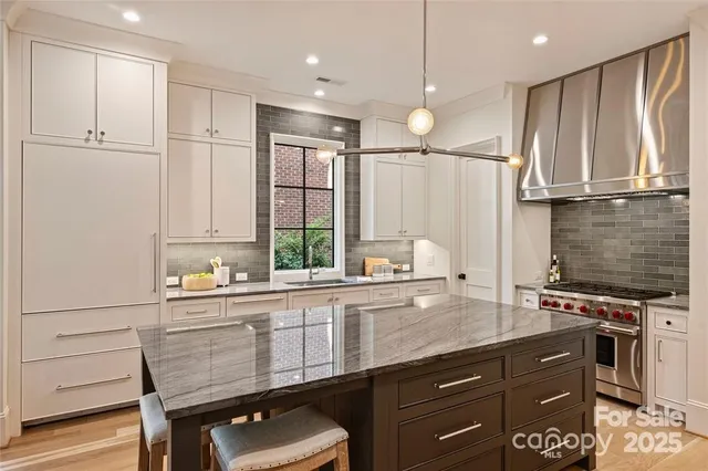 a kitchen with stainless steel appliances a sink stove and refrigerator