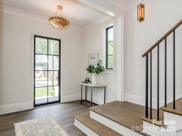 a view of a livingroom with wooden floor and a potted plant