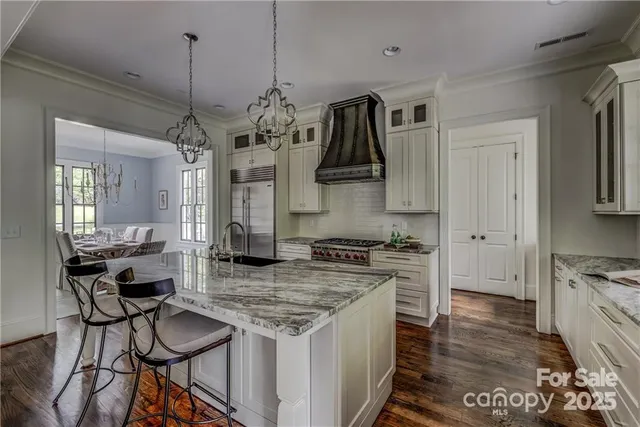 a kitchen with stainless steel appliances granite countertop a stove and a refrigerator