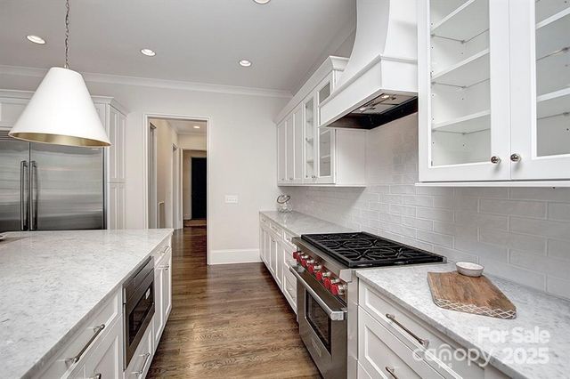 a kitchen with a stove and a refrigerator