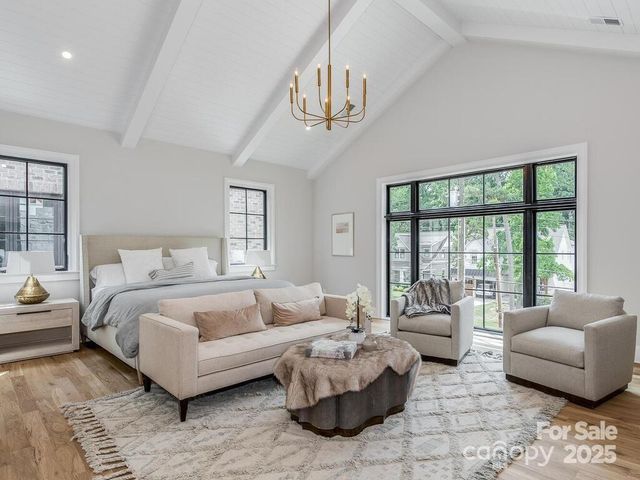 a spacious bedroom with a bed a couch and a couch