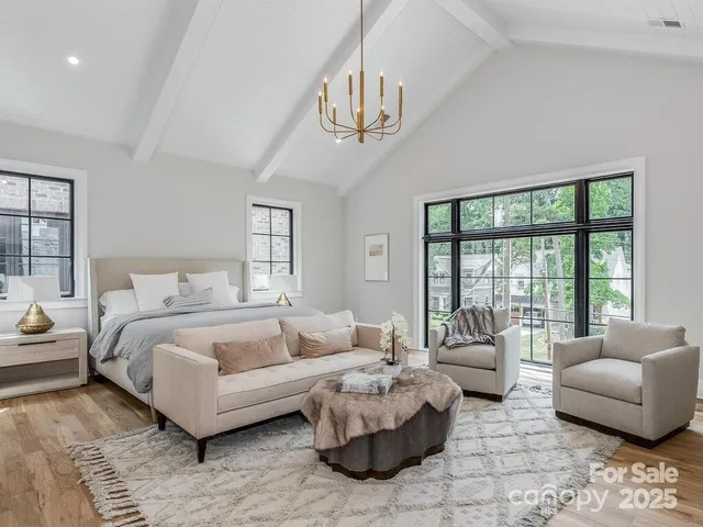 a spacious bedroom with a bed a couch and a couch