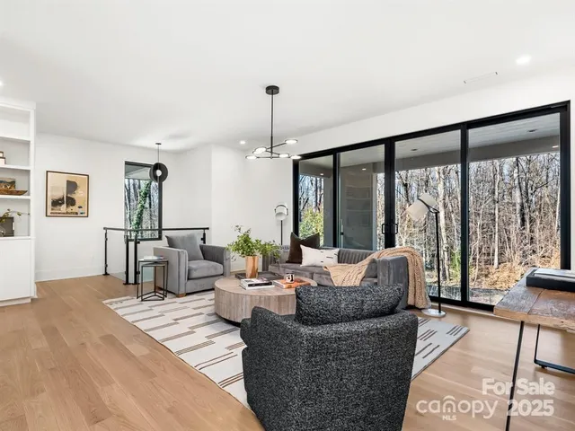 a living room with furniture and large windows