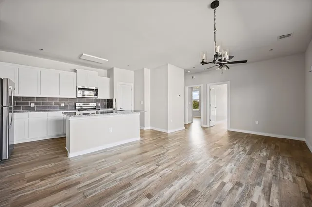 an empty room with window and natural light