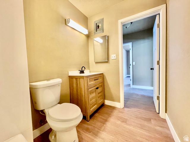 255 West Main Street Mount Pleasant, UT 84647 - Photo 23 of 35 Bathroom with wood-finish flooring, a light wood-tone vanity, and a white countertop