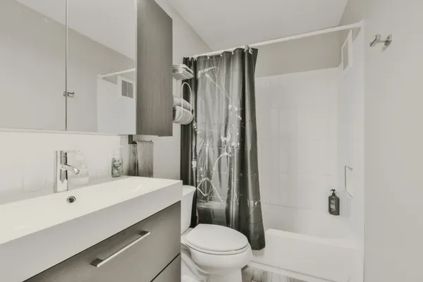 a bathroom with a sink toilet and shower