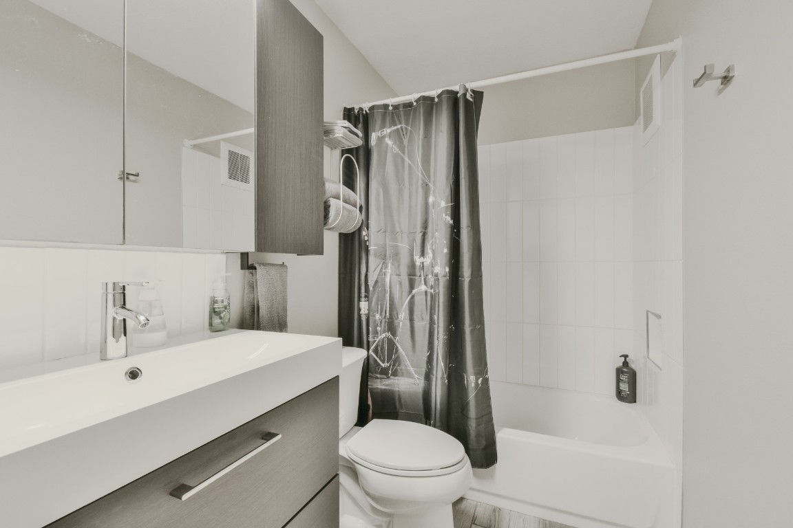 2302 East Side Drive, Unit 6 Austin, TX 78704 - Photo 4 of 7 a bathroom with a sink toilet and shower