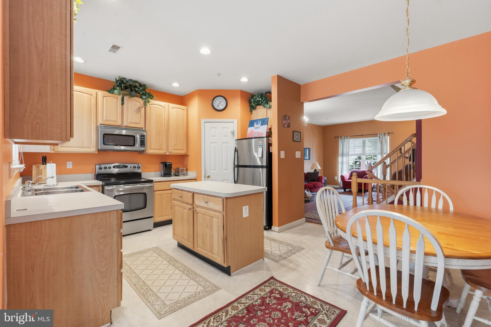 3132 Raking Leaf Drive Abingdon, MD 21009 - Photo 12 of 31 a kitchen with stainless steel appliances granite countertop a refrigerator a stove a sink and a dining table with white cabinets