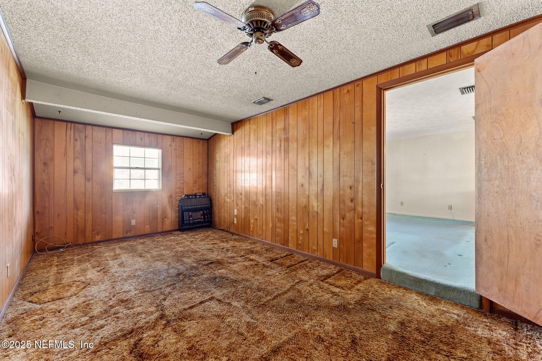 10887 Player Road West Jacksonville, FL 32218 - Photo 15 of 26 an empty room with windows and fan