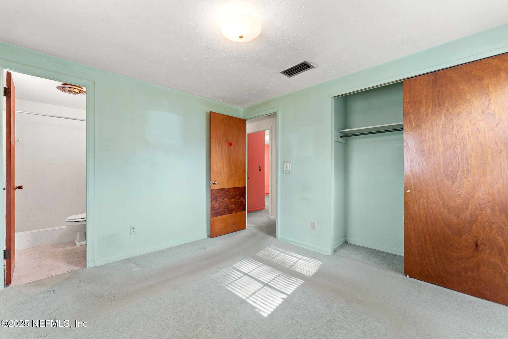 10887 Player Road West Jacksonville, FL 32218 - Photo 17 of 26 an empty room with closet and mirror
