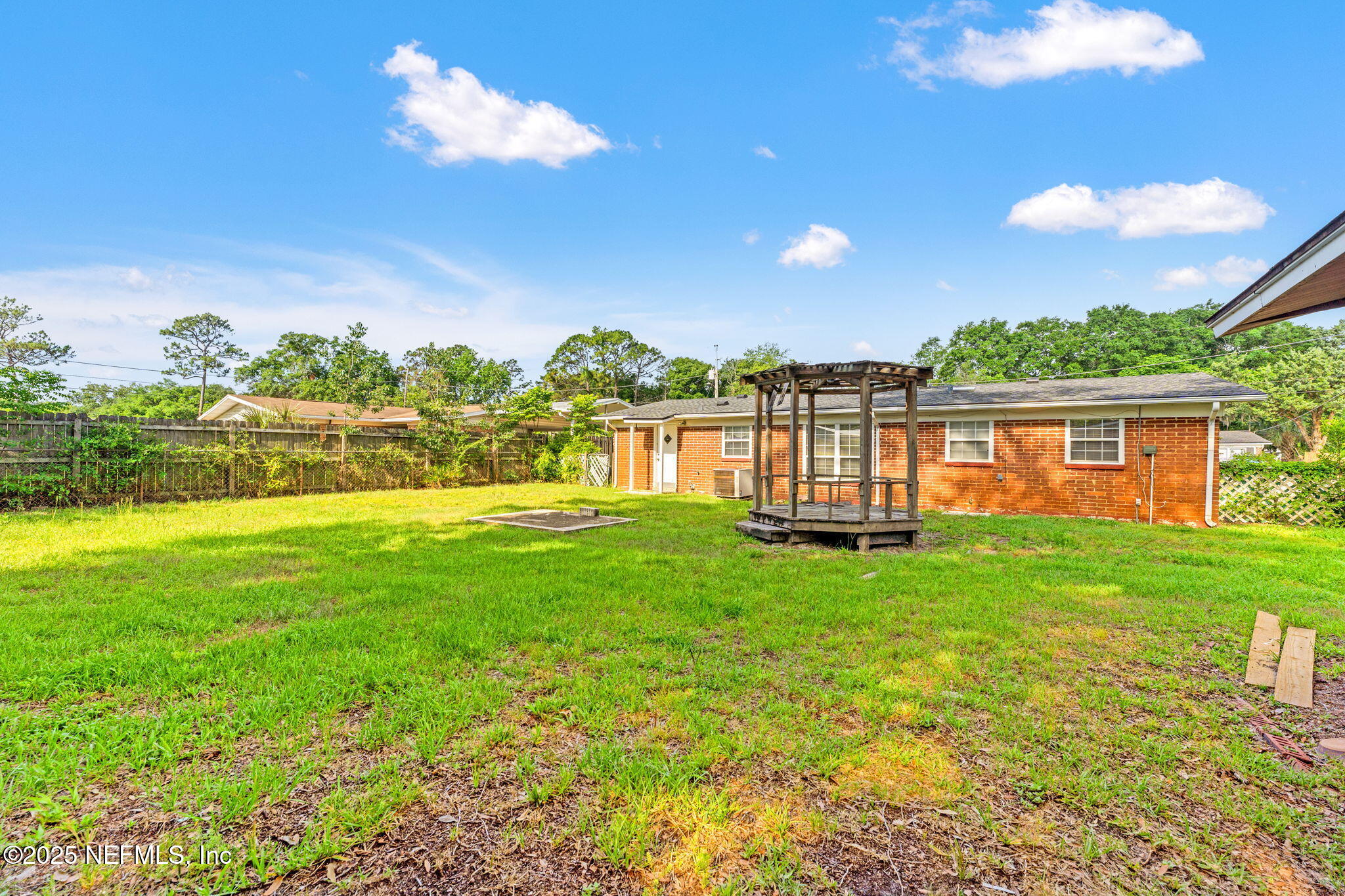 10887 Player Road West Jacksonville, FL 32218 - Photo 26 of 26 a view of a house with a backyard and a patio