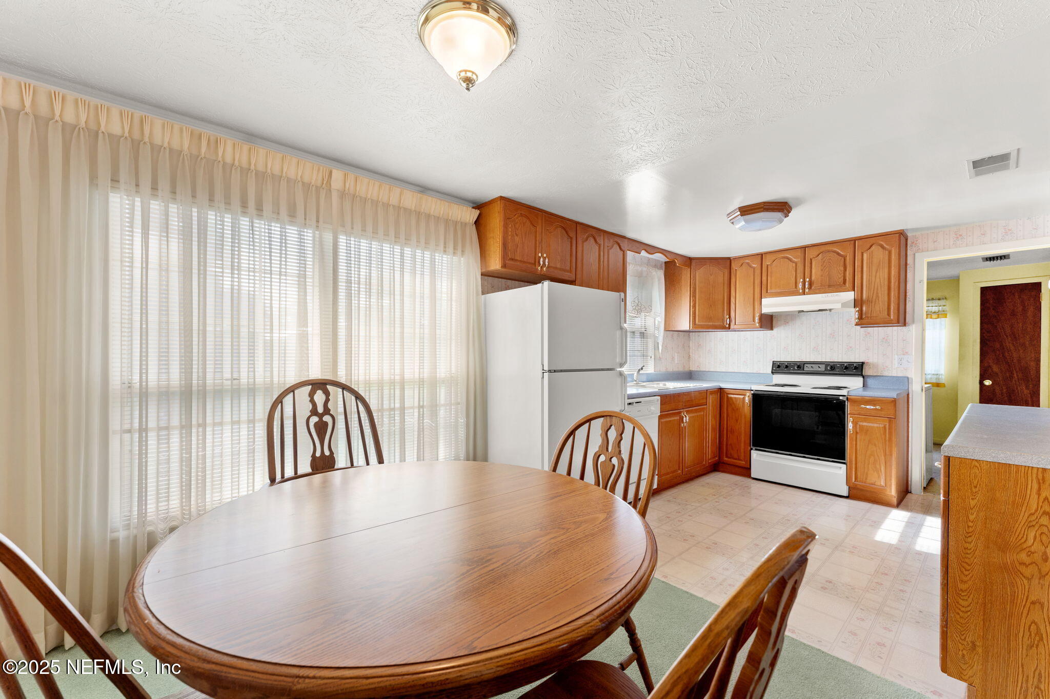 10887 Player Road West Jacksonville, FL 32218 - Photo 7 of 26 a dining room with furniture and a kitchen view