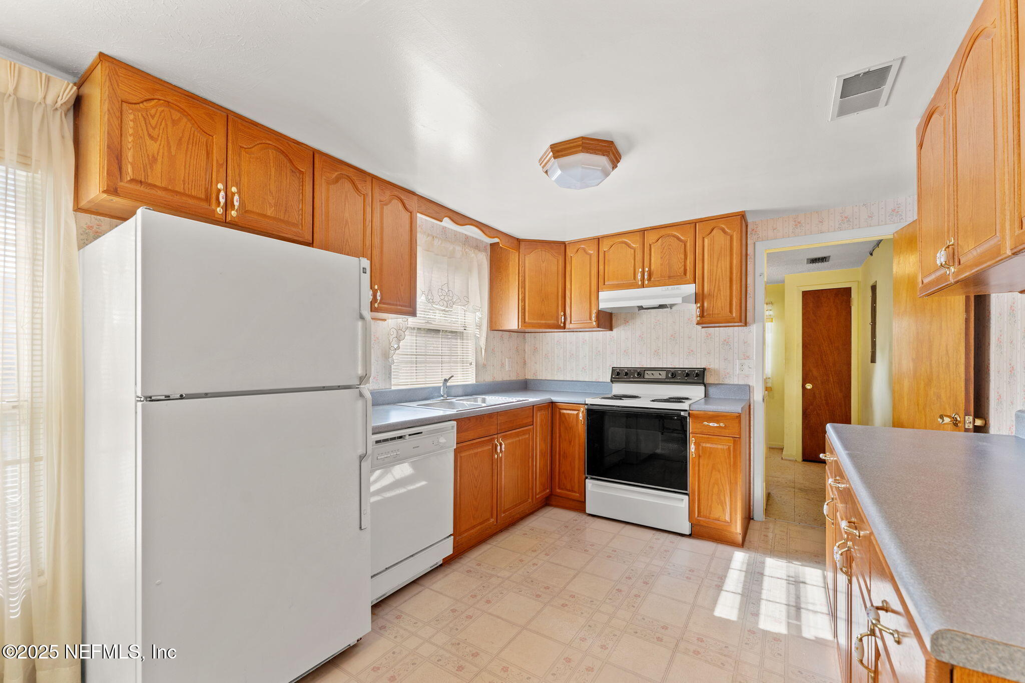 10887 Player Road West Jacksonville, FL 32218 - Photo 8 of 26 a kitchen with stainless steel appliances granite countertop a refrigerator a stove a sink and a refrigerator
