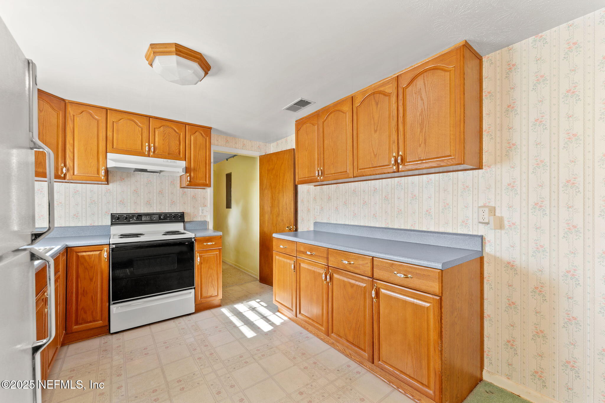 10887 Player Road West Jacksonville, FL 32218 - Photo 10 of 26 a kitchen with stainless steel appliances granite countertop a stove a sink and a microwave