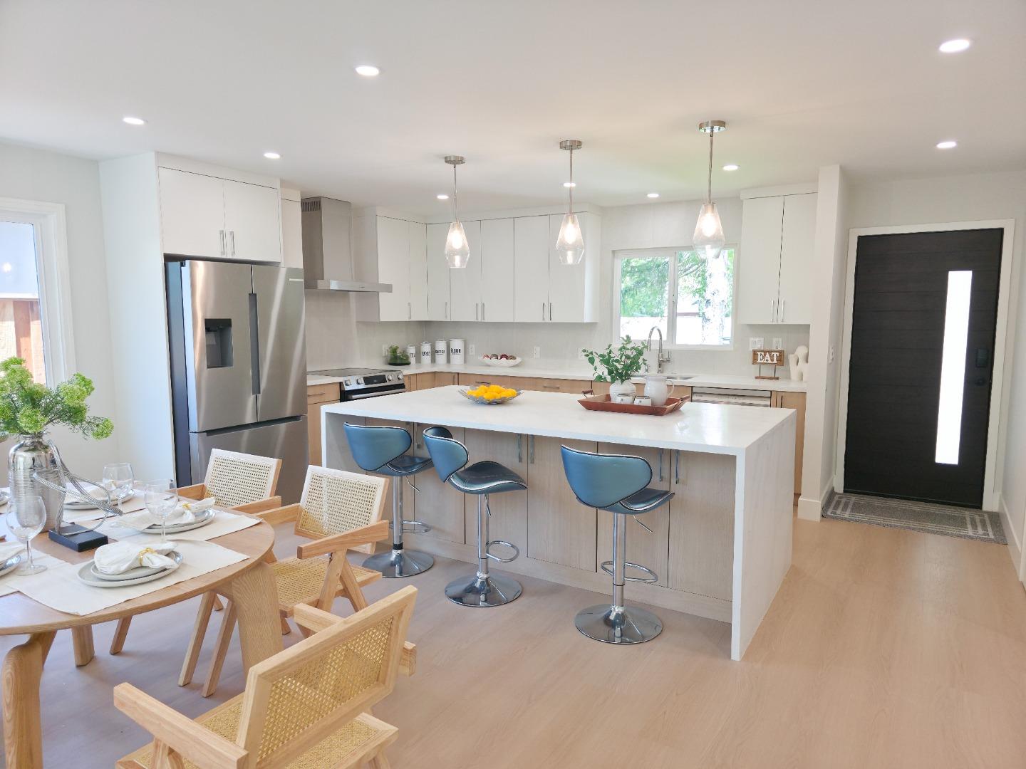 6746 Bollinger Road San Jose, CA 95129 - Photo 4 of 30 a kitchen with stainless steel appliances kitchen island granite countertop a dining table and chairs