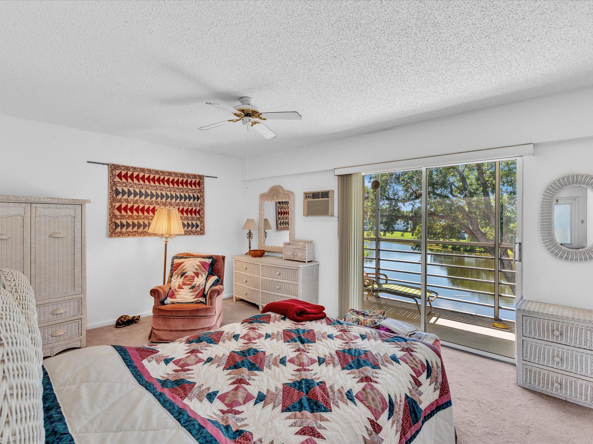 289 Fanshaw Drive, Unit G Boca Raton, FL 33434 - Photo 11 of 39 a bedroom with a bed and wooden floor