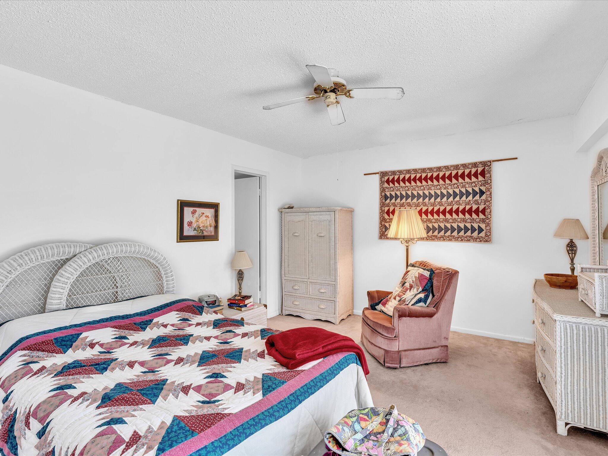 289 Fanshaw Drive, Unit G Boca Raton, FL 33434 - Photo 12 of 39 a bedroom with furniture and a wooden floor
