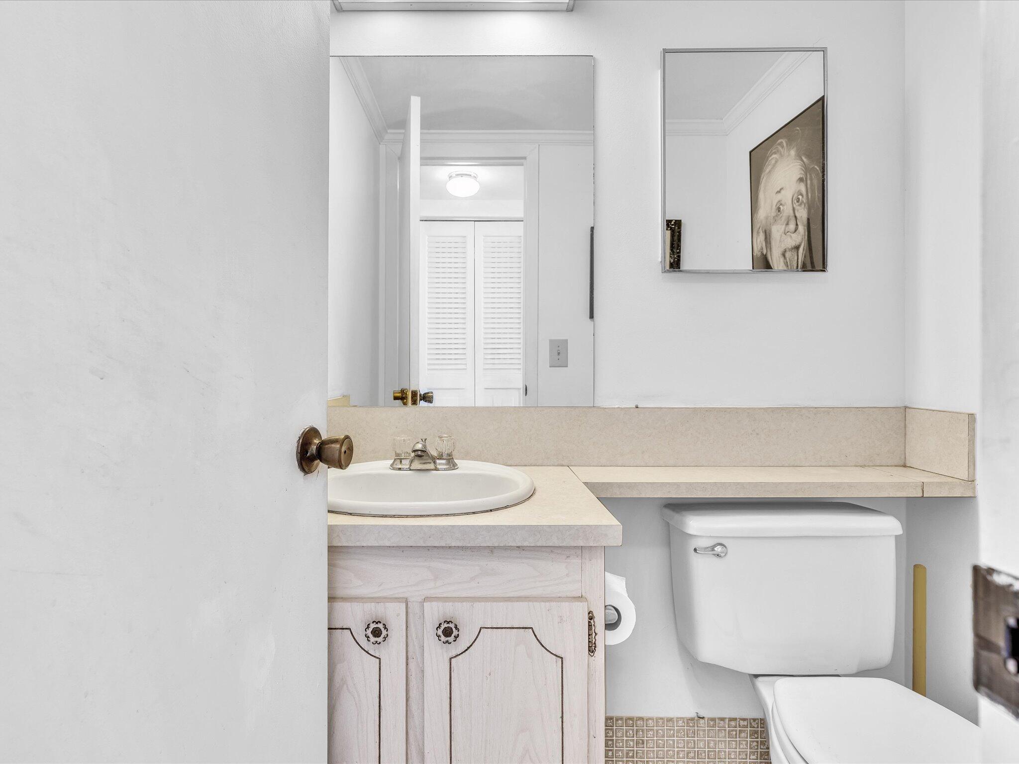 289 Fanshaw Drive, Unit G Boca Raton, FL 33434 - Photo 15 of 39 a bathroom with a sink mirror and toilet