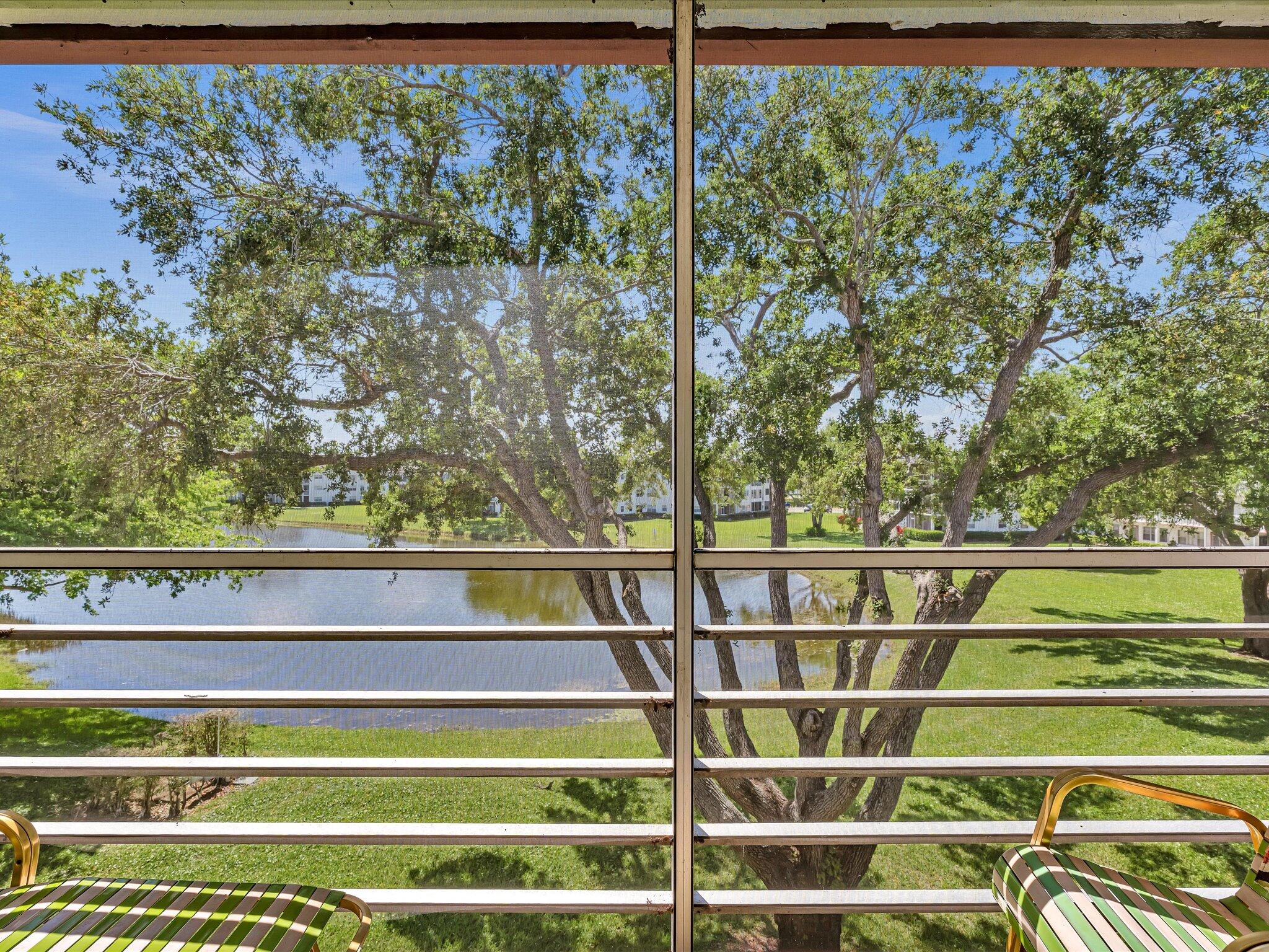 289 Fanshaw Drive, Unit G Boca Raton, FL 33434 - Photo 19 of 39 a view of a lake from a balcony