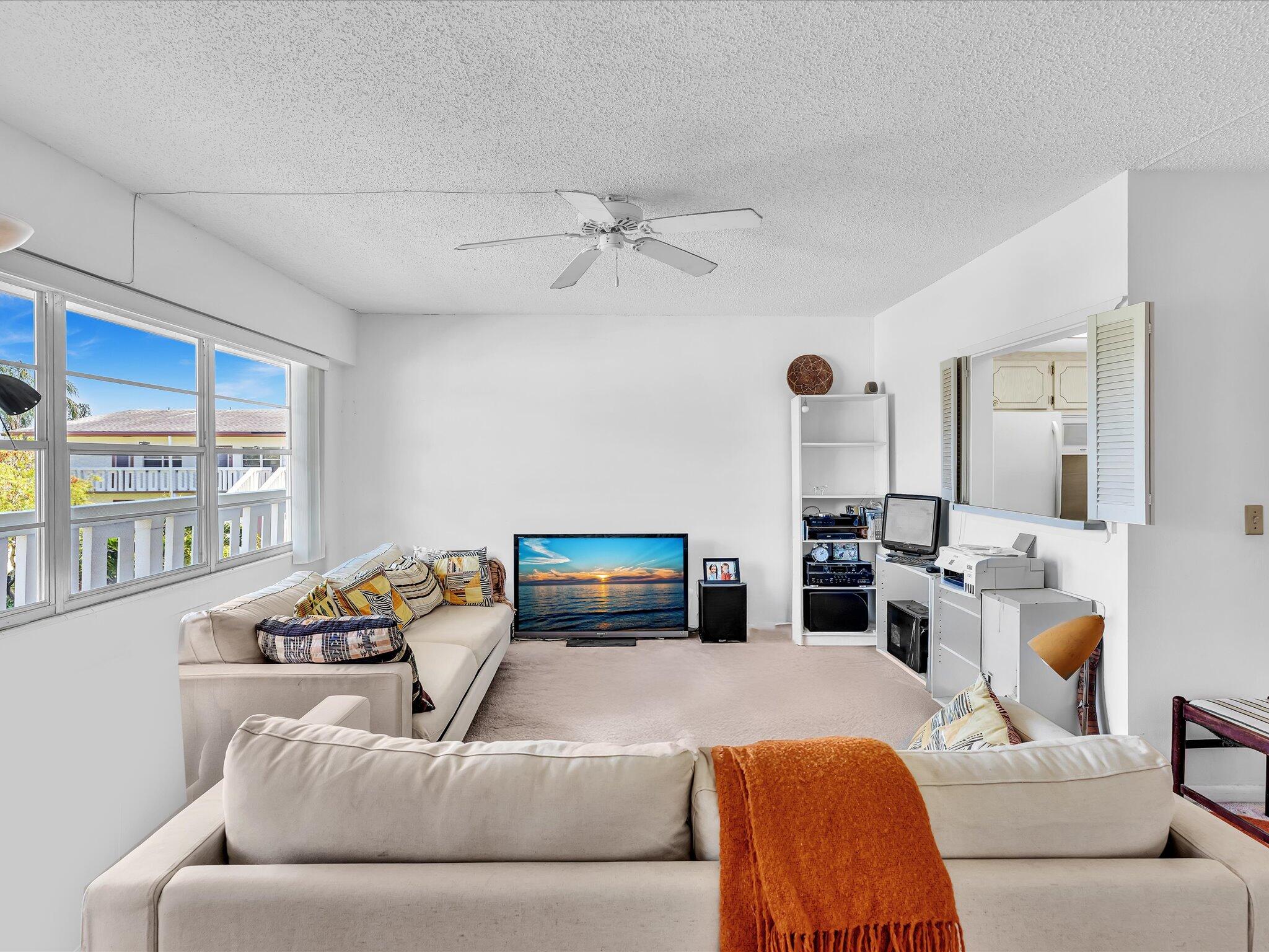 289 Fanshaw Drive, Unit G Boca Raton, FL 33434 - Photo 6 of 39 a living room with furniture and a large window