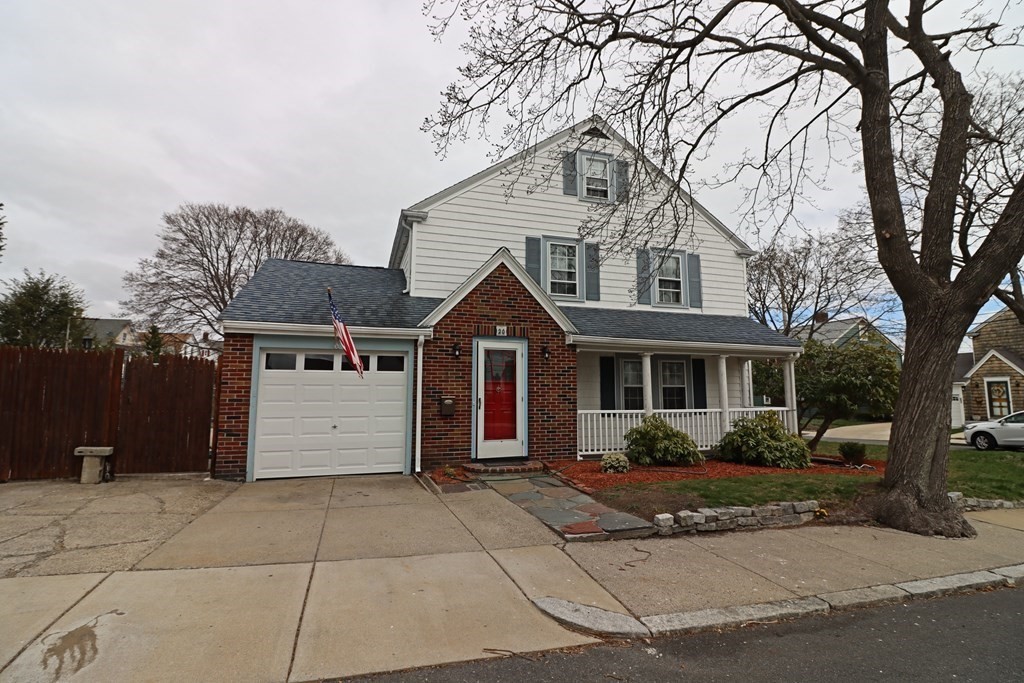 a front view of house with yard and trees around