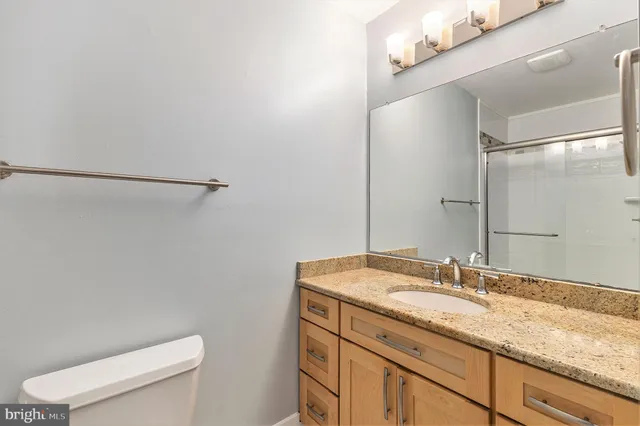 a view of a house with a yard and large tree