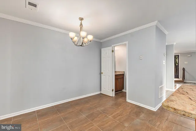 a kitchen with stainless steel appliances granite countertop a refrigerator a sink dishwasher a stove with white cabinets