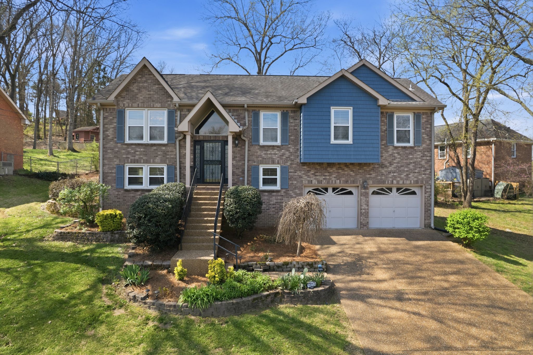 1049 Fitzpatrick Road Nashville, TN 37214 - Photo 1 of 38 a front view of a house with garden